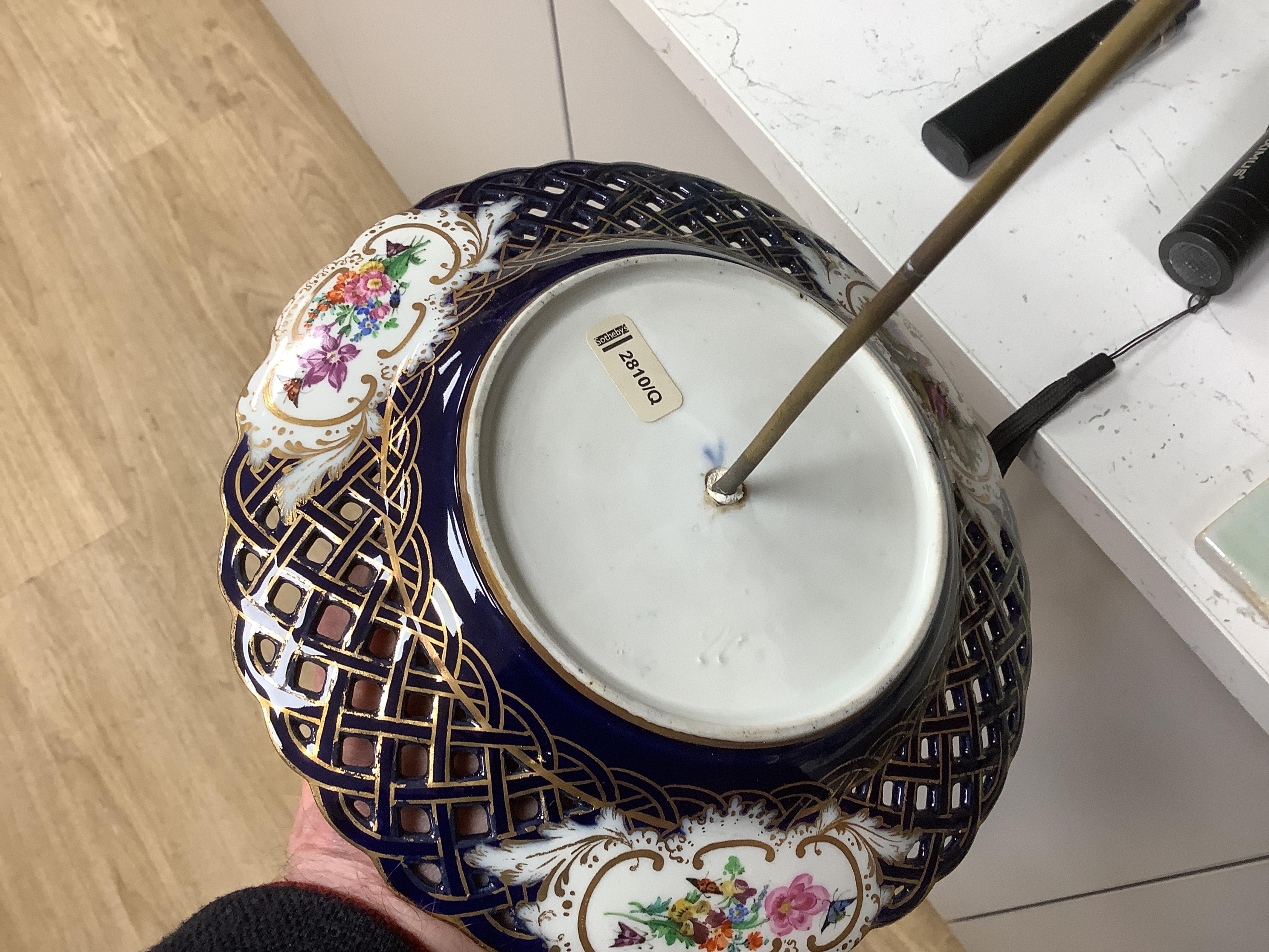 A pair of late 19th century Meissen three tier cake stands with figural tops, 48cm high